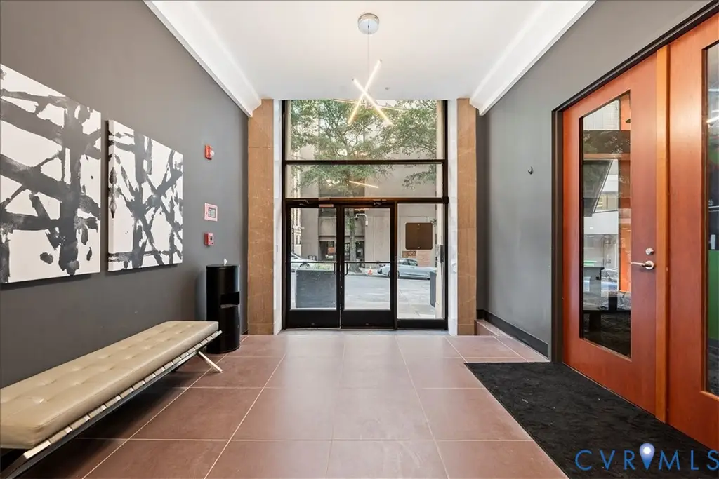 Lobby of 6 North 6th Street with abstract artwork, a leather bench, and floor-to-ceiling glass doors opening onto 6th Street